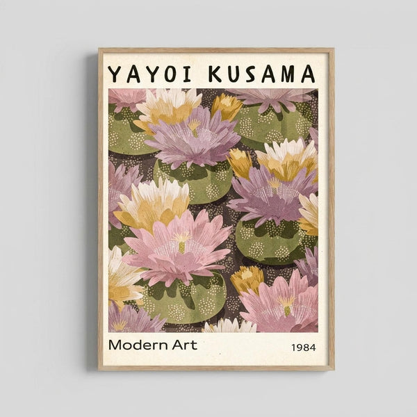 May include: Framed art print displaying colorful water lilies in pink, purple, yellow and white floating on green lily pads with dotted textures against dark water. The botanical artwork features "YAYOI KUSAMA" at top and "Modern Art 1984" at bottom in black text on cream background. Light wood frame hangs on white wall.