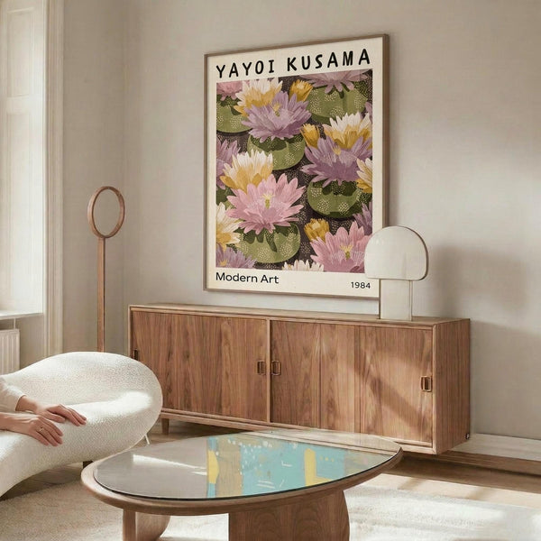 May include: Framed poster featuring colorful water lilies in pink, purple, yellow and white floating on dark water with lily pads, displayed above a mid-century modern walnut credenza in a minimalist living room with white egg chair, glass coffee table, and brass floor lamp
