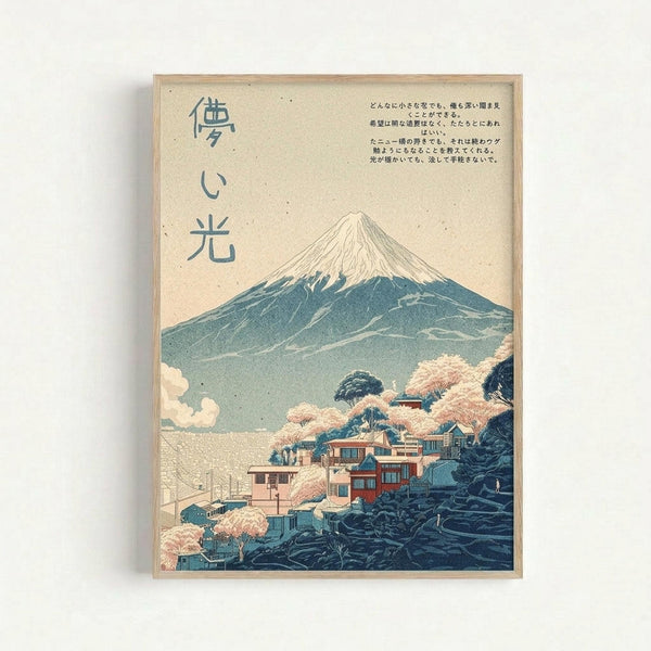 May include: Framed Japanese-style artwork showing Mount Fuji with snow-capped peak rising above a village of traditional buildings surrounded by pink cherry blossoms. The print features muted blue, pink, and cream tones with Japanese characters on the left side and text in the upper right corner. The artwork is displayed in a light wood frame against a white wall, showing the vintage ukiyo-e aesthetic with soft, layered colors and classical composition.