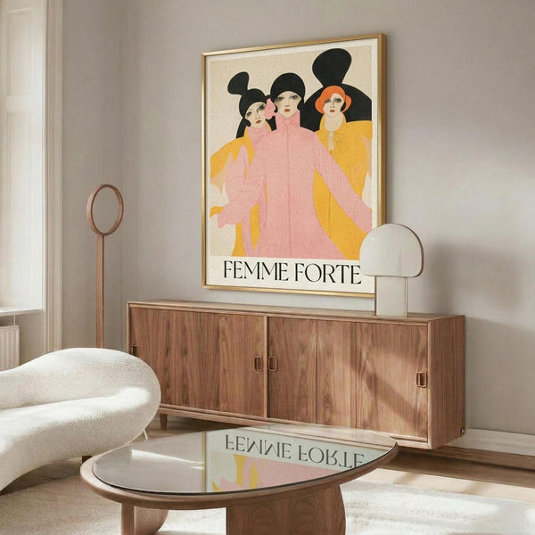 May include: Framed vintage-style poster featuring three women in pink and yellow clothing with black silhouettes behind them, displayed above a walnut wood credenza in a modern living room with cream walls, white upholstered chair, glass coffee table, and warm natural lighting creating reflections on the floor.