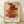 May include: Framed poster print featuring abstract geometric composition with overlapping translucent rectangular blocks in warm colors including reds, oranges, yellows, and browns arranged vertically on cream background. Text reads "architectural poem" at top, "PAUL KLEE" in large black letters, "PLAYFUL ABSTRACTION MODERNISM" below, and "1879-1940" at bottom right. Light wood frame sits against white wall on wooden floor with natural shadows.