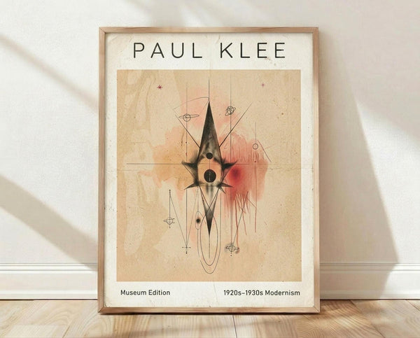 May include: Framed poster print leaning against white textured wall on light wood floor. Abstract modernist artwork features geometric shapes, lines, and watercolor-like washes in beige, pink, and black tones on aged paper background. Natural wood frame with white matting. Soft shadows cast across scene from natural lighting.