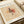 May include: Abstract modernist artwork print with geometric black angular shapes, circular forms, and red watercolor accents on beige textured background. The poster features thin intersecting lines and small symbolic elements scattered throughout. Shown as a museum-style print with white border containing "PAUL KLEE" text and "1920s-1930s Modernism Museum Edition" details, displayed alongside rolled paper tubes on neutral surface.