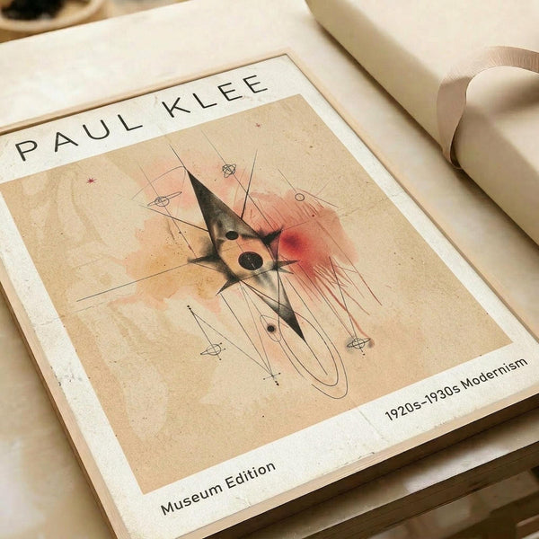 May include: Abstract modernist artwork print with geometric black angular shapes, circular forms, and red watercolor accents on beige textured background. The poster features thin intersecting lines and small symbolic elements scattered throughout. Shown as a museum-style print with white border containing "PAUL KLEE" text and "1920s-1930s Modernism Museum Edition" details, displayed alongside rolled paper tubes on neutral surface.