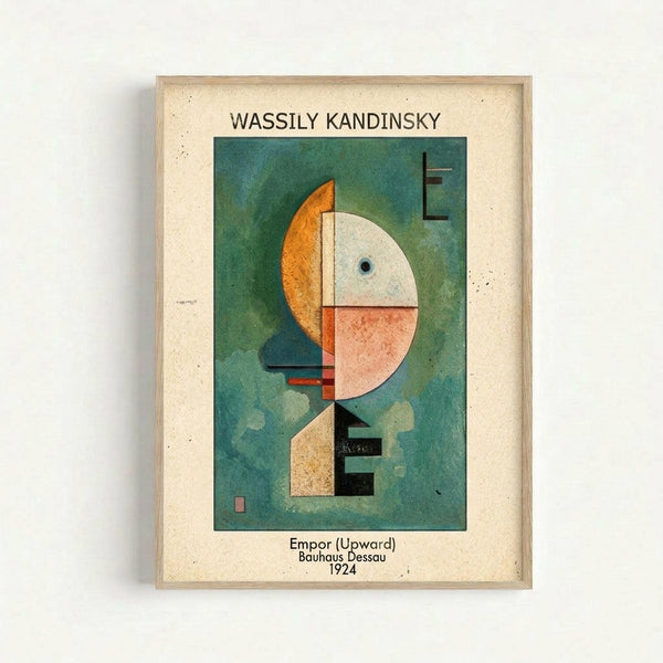 Framed abstract art print featuring geometric shapes in vibrant colors on a teal-green background. The composition includes a large white circle, orange curved form, coral pink section, and black linear elements arranged vertically. Text above reads "WASSILY KANDINSKY" and below states "Empor (Upward) Bauhaus Dessau 1924". The artwork is displayed in a light wood frame with cream matting against a white wall.