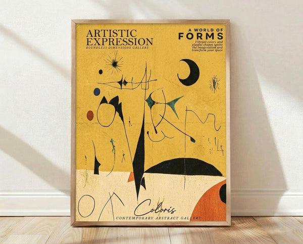 May include: Framed abstract art poster with yellow background featuring black geometric shapes, crescent moon, starburst designs, and colorful organic forms in Joan Miró style. The wooden-framed print displays "Artistic Expression" and "A World of Forms" text at top, with "Coloris Contemporary Abstract Gallery" at bottom. Orange and teal accent colors complement the minimalist composition, shown leaning against white wall on light wooden floor.