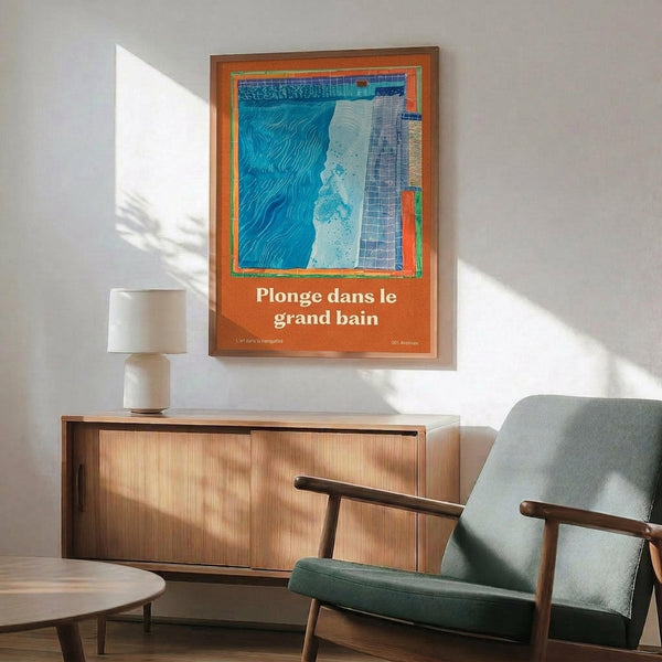 May include: Framed poster with blue and orange abstract design featuring pool-like imagery and French text "Plonge dans le grand bain" displayed above mid-century modern wood credenza with ceramic table lamp. Green upholstered armchair with wooden frame sits nearby in sunlit room with white walls and wooden floors.