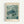 May include: Framed art print hanging on white wall featuring a detailed illustration of a sea turtle swimming among coral or seaweed in muted green and teal tones. The print has cream-colored borders with "YAYOI KUSAMA" at top, "Modern Art" and "1966" at bottom. Natural wood frame surrounds the vintage-style poster with Japanese artistic influence and organic underwater botanical elements.