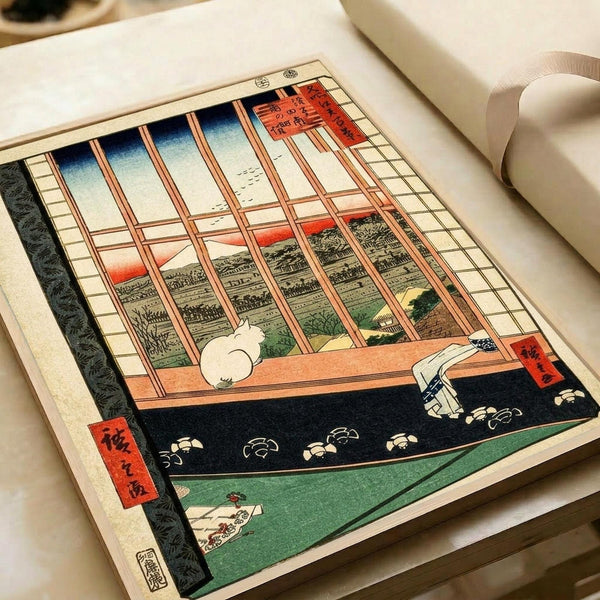 May include: Japanese woodblock print displayed in open art book showing interior scene with wooden lattice window overlooking landscape at sunset. White cat sits on windowsill beside scattered sandals on dark floor. Traditional ukiyo-e style with red cartouche text, muted colors of blue sky, orange horizon, and green tatami mat. Print appears vintage with cream paper background.