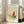 May include: Framed poster featuring an abstract butterfly design in yellow, orange, and teal geometric shapes with thin black outlines on beige textured background. Text reads "PICASSO" at top and "Uffizi Gallery Collection de Dessins" at bottom. Light wood frame leans against white wall next to beige sectional sofa in bright room with large windows.
