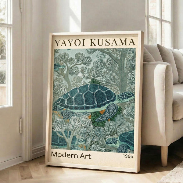 May include: Framed art print featuring a detailed sea turtle swimming among coral and sea plants in muted green and teal tones, displayed on wooden floor against white wall next to beige upholstered chair. The vintage-style poster has "YAYOI KUSAMA" at top and "Modern Art 1966" at bottom in black text on cream background.