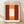 May include: Framed art print featuring abstract color field painting with warm orange and deep red rectangular forms surrounding a white central rectangle, displayed in light wood frame against white wall on wooden floor with natural lighting casting soft shadows