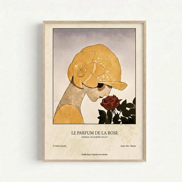 May include: Framed vintage-style art print showing a woman in golden yellow head wrap smelling a deep red rose against a soft purple-gray background. The minimalist illustration uses warm earth tones and geometric shapes. Light wood frame with cream matting displays the poster on a white wall. French text below reads "LE PARFUM DE LA ROSE" with additional publication details.