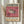 May include: Framed exhibition poster with pink background featuring detailed pufferfish illustration, displayed on white wall next to dried pampas grass. Poster shows vintage 1974 gallery exhibition design with Japanese and English text, venue details for San Francisco Japantown location, and artist names at bottom.