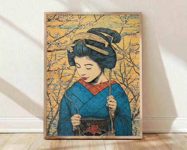 May include: Framed poster print leaning against white wall on light wood floor. Artwork shows Japanese woman in traditional blue kimono with geometric patterns and red collar, elaborate dark hair with ornate pins, holding thin sticks or chopsticks. Background features golden yellow tones with delicate cherry blossom branches. Art style resembles vintage Japanese woodblock prints with detailed line work and muted color palette. Natural wood frame visible around edges.