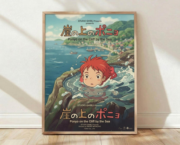 May include: Framed Studio Ghibli Ponyo movie poster print leaning against white textured wall on light wood floor. Features red-haired Ponyo character swimming in ocean water with coastal village in background. Japanese and English text visible. Natural wood frame with glass. Soft natural lighting creates gentle shadows on wall.