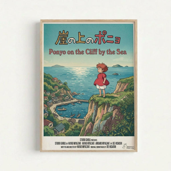 A framed vintage-style poster featuring Studio Ghibli's Ponyo on the Cliff by the Sea. The artwork shows a small girl with reddish hair in a red dress standing on a grassy cliff overlooking a coastal village with traditional houses, boats in the harbor, and blue ocean with distant islands. Japanese text appears at the top with English translation below. The poster has a turquoise to pale blue gradient sky and is displayed in a light wood frame against a white wall.