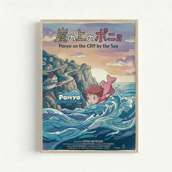 Framed poster of Studio Ghibli's Ponyo on the Cliff by the Sea featuring the red-haired fish girl character swimming in stylized blue ocean waves with white caps. A clifftop village with small houses sits on rocky cliffs in the background under a dreamy sunset sky painted in soft purples, pinks and yellows. Japanese text appears at the top with English translation below, plus film credits at the bottom. The artwork has Miyazaki's distinctive hand-drawn animation style in a light wood frame.