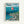 Framed poster featuring Studio Ghibli's Ponyo anime artwork with Japanese and English text at top. Shows red-haired child character Ponyo floating in ocean water above a detailed coastal Japanese village with traditional houses, boats in harbor, and winding roads. Art style is colorful hand-drawn animation with blue ocean, cloudy sky, and green hillside town below. Natural wood frame against white wall.