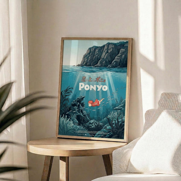 May include: Framed poster with underwater scene showing red-haired character swimming among sea plants and rocks, with cliffs above water surface. Wooden frame on round wooden side table next to beige upholstered chair, with plant shadows casting across white wall in bright natural lighting.