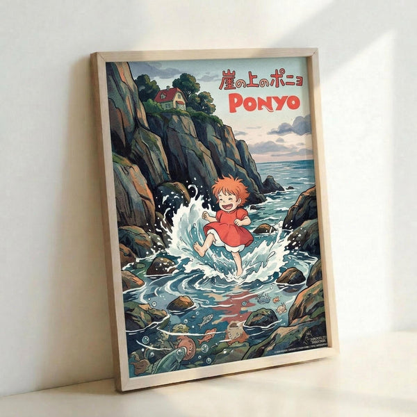May include: Framed poster print leaning against white wall showing anime-style artwork of red-haired child in red dress splashing through tide pools among rocky cliffs. Ocean waves crash around dark rocks with sea creatures visible underwater. Small house sits atop cliff in background. Japanese text and "PONYO" title in red letters across top. Light wood frame, vintage illustration style with muted blues, greens, and earth tones.