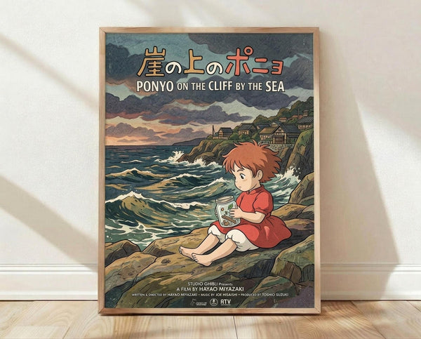 May include: Framed Studio Ghibli Ponyo movie poster print leaning against white textured wall on light wood floor. Artwork shows red-haired child in red dress sitting on rocky coastline holding glass jar, with stormy ocean waves, dramatic cloudy sky, and hillside village in background. Natural wood frame, vintage illustration style with muted greens, blues, and warm earth tones.