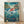 May include: Framed Studio Ghibli poster showing red-haired character Ponyo swimming through swirling ocean waves above an underwater scene with colorful fish, jellyfish and sea plants. Above water shows coastal village with lighthouse, houses and boats. Japanese and English text visible. Wooden frame displayed against white wall on light wood floor with soft shadows.