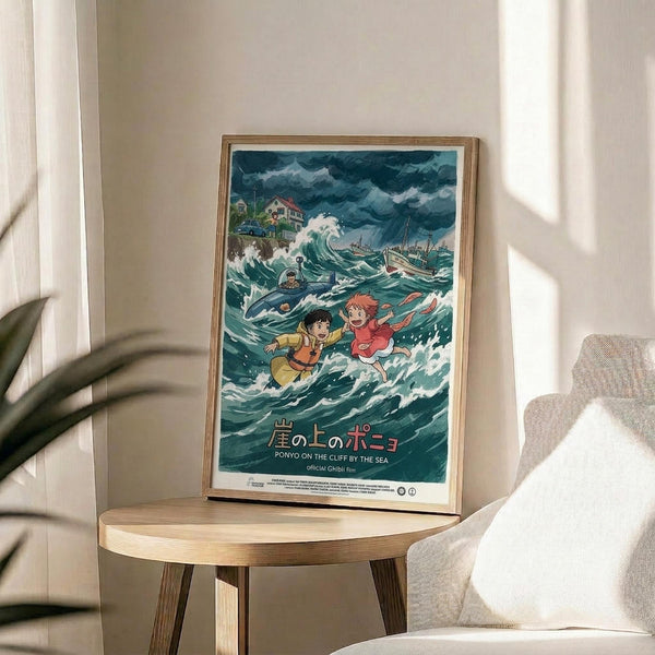 May include: Framed poster of animated characters in stormy ocean waves, featuring two children and sea creatures amid turbulent blue-green waters with boats and cliffs in background. Wooden frame sits on round wooden side table next to beige upholstered chair with decorative plant shadows cast on cream wall behind.