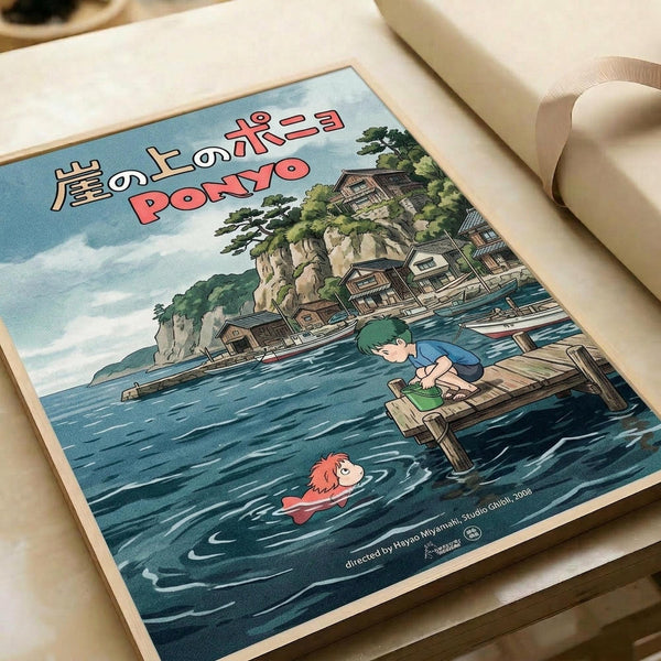 May include: Vintage-style poster print featuring Studio Ghibli's Ponyo anime artwork displayed on white paper with rolled paper tube nearby. Shows coastal Japanese village scene with green-haired boy on wooden dock reaching toward red-haired girl swimming in blue ocean water. Traditional houses built into rocky cliffs with lush trees in background under cloudy sky. Japanese text at top, director credit at bottom.