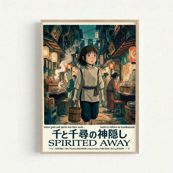 A framed poster featuring anime-style artwork of a young girl with short dark hair wearing traditional Japanese clothing, standing in a bustling traditional street market. The scene shows wooden buildings, paper lanterns, food stalls with steaming dishes, and people dining. The illustration uses warm earth tones and detailed architectural elements. Japanese text and "SPIRITED AWAY" appear at the bottom with film credits. The poster is displayed in a light wooden frame against a white wall.