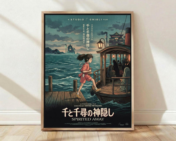 May include: Framed Studio Ghibli Spirited Away movie poster showing young girl Chihiro in red outfit standing on wooden dock beside traditional boat filled with shadowy passengers. Turquoise ocean waters stretch toward distant lighthouse and pagoda under cloudy twilight sky. Japanese text at top, English title at bottom. Natural wood frame sits on light wooden floor against white wall with soft shadows.