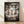 May include: Framed Studio Ghibli Spirited Away movie poster displayed on light wood floor against white wall with soft shadows. The colorful anime artwork shows a young girl in pink shirt standing before a traditional Japanese torii gate, surrounded by iconic film characters including No-Face, dragon, forest spirits, and magical creatures in a dreamy, ethereal scene with paper lanterns and mystical atmosphere.