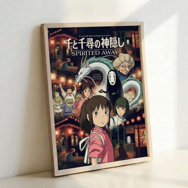 May include: Framed poster of animated movie artwork featuring a young girl with dark hair in pink clothing in the foreground, surrounded by colorful characters including a white dragon, masked figure, and elderly woman. Japanese text at top with "SPIRITED AWAY" below. Warm-toned scene shows traditional buildings with lanterns in background. Light wooden frame leaning against white wall.