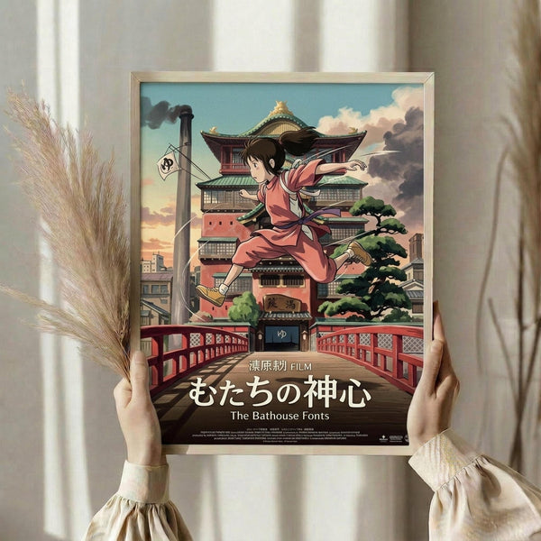 May include: Person holding framed poster featuring anime girl in pink kimono leaping above traditional Japanese bathhouse with red bridge, set against cloudy sky. Warm-toned room with dried pampas grass and soft lighting. Japanese text at bottom of poster.