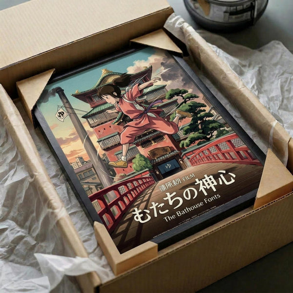May include: Framed anime-style poster showing a girl in flowing pink robes leaping through a traditional Japanese bathhouse setting with pagoda buildings, red bridges, and colorful architecture. The artwork is displayed in a black frame inside an open cardboard shipping box with white tissue paper padding. Japanese text appears at the bottom of the poster along with "The Bathhouse Fonts" in English.