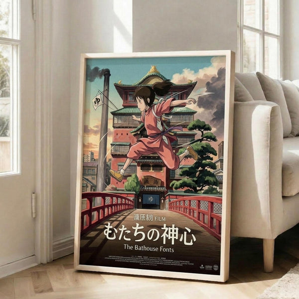 May include: Framed anime poster leaning against white wall next to beige sofa in bright living room. Artwork shows young girl in pink outfit jumping over red bridge with traditional Japanese bathhouse building in background. Colorful illustration features turquoise sky, green trees, and Japanese text at bottom. White wooden frame on light hardwood floors with natural window lighting.