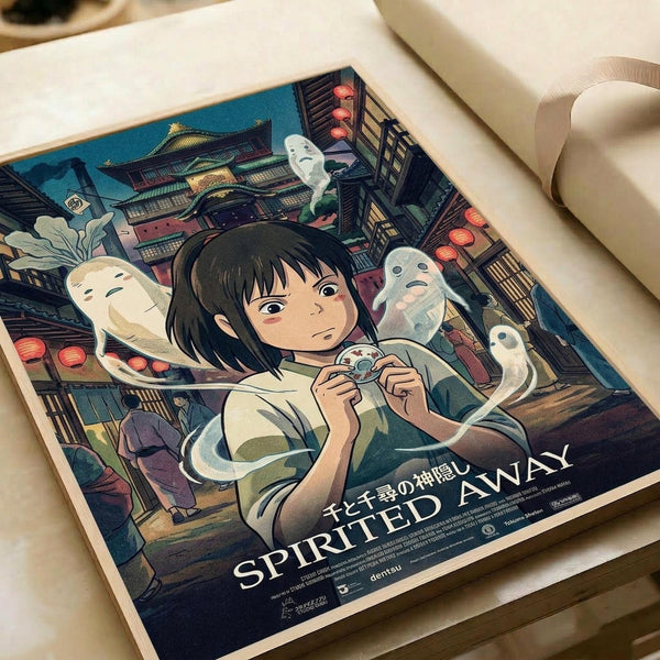 May include: Animated movie poster featuring a young girl with short dark hair surrounded by white spirit creatures in a colorful Japanese bathhouse setting with red lanterns and traditional architecture. The poster shows "SPIRITED AWAY" text at bottom and lies flat on white paper with rolled paper visible in background.