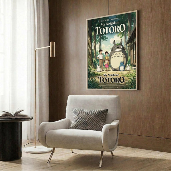 May include: Studio Ghibli My Neighbor Totoro movie poster mounted on wood-paneled wall above beige upholstered armchair with geometric patterned pillow. Poster shows large gray Totoro character with children and smaller forest spirits in green woodland setting. Modern reading nook with brass floor lamp and side table with open book.