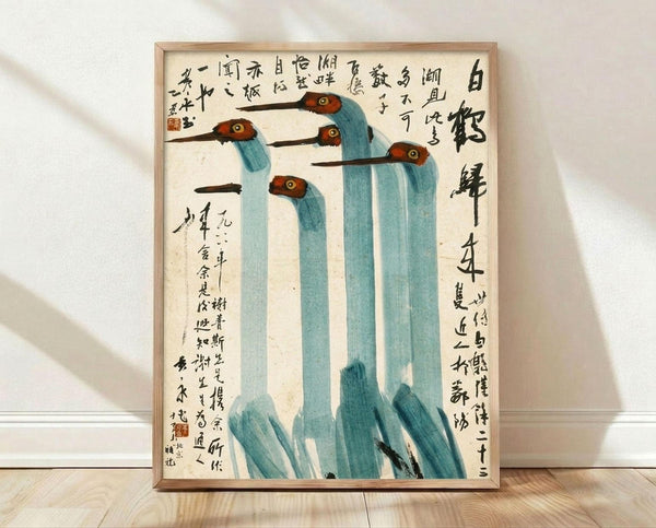 May include: Framed vintage Chinese ink painting featuring five blue-green cranes with red-orange heads and long dark beaks, surrounded by traditional black calligraphy text on cream paper. The wooden-framed artwork leans against a white wall on light wood flooring with soft shadows cast across the scene.
