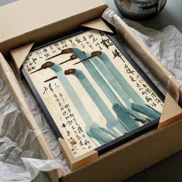 May include: Framed Chinese watercolor painting of five blue-green cranes with brown heads and long black beaks, surrounded by traditional calligraphy text. The artwork sits in a black frame inside an open cardboard shipping box with white tissue paper padding on a white surface.