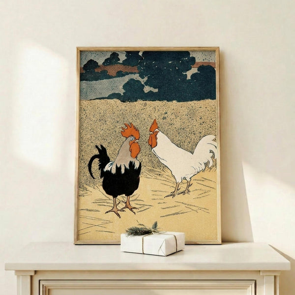 May include: Vintage-style poster print featuring two roosters on sandy ground beneath a dramatic cloudy sky, displayed in thin wooden frame on light wood surface. One rooster is black and white with orange comb, the other is white with orange details. Small wrapped gift with evergreen sprig sits beside the framed artwork against cream wall.