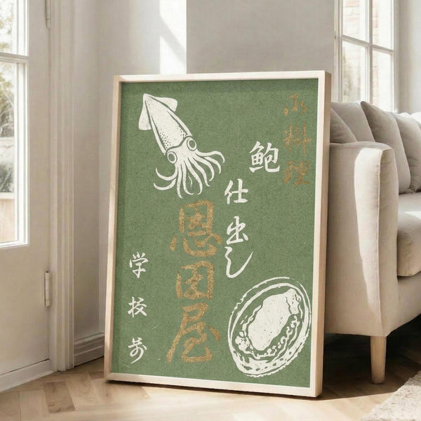May include: A framed vintage-style Japanese seafood poster with green background displayed in a bright living room. The artwork features white illustrations of a squid and abalone shell with Japanese characters in white and gold text. The wooden-framed print leans against a white wall next to a beige upholstered sofa, with natural sunlight streaming through tall windows onto hardwood floors.