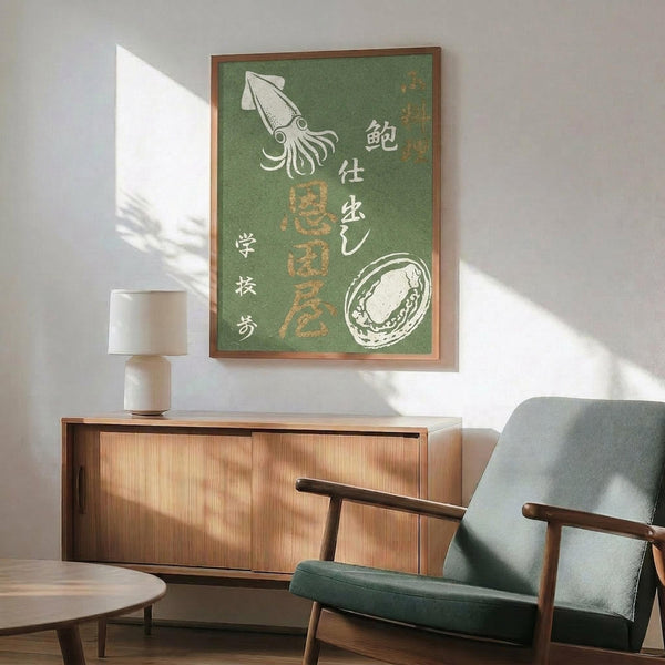May include: Green vintage-style Japanese poster featuring white squid and abalone illustrations with Japanese text, displayed in wooden frame above mid-century modern credenza with ceramic lamp, next to sage green upholstered chair with wood arms in sunlit room with white walls.