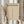May include: Person in cream sweater holding framed minimalist poster with beige background, featuring bold BAUHAUS text, "LESS IS MORE" quote, and vertical row of geometric triangles. Natural light streams through window behind figure holding dried pampas grass. Light wood frame complements neutral tones.