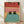 May include: Framed poster print leaning against white wall on light wood floor. Artwork shows two black cats with bright yellow eyes soaking in turquoise bath water inside wooden bathtub. Background features coral and salmon pink tiled bathroom walls with black geometric elements and circular window detail. Illustration has clean cartoon style with bold colors and simple lines.