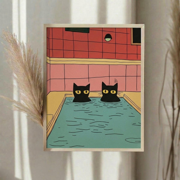 May include: Framed poster print hanging on white wall showing two black cats with yellow eyes sitting in a turquoise swimming pool. The illustration features coral pink tile walls, yellow pool deck, and bold geometric line art style. Dried pampas grass in vase visible to the left of the light wood frame.