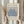 May include: Hands holding a framed art print featuring blue coral-like botanical shapes on beige background with "MATISSE" and "BERGGRUEN & CIE" text. Light wood frame, neutral curtain backdrop, dried pampas grass visible to left side.