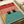 May include: Vintage-style illustration print showing two black cats with yellow eyes peeking out from a turquoise swimming pool or bathtub. The scene features coral pink tiled walls with black grid lines, yellow pool edging, and retro mid-century modern aesthetic. Print appears flat against white wrapping paper with tape roll visible nearby.