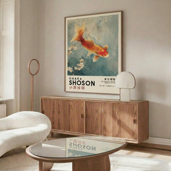 May include: Framed poster featuring a golden-orange koi fish swimming among cherry blossoms in Japanese art style, displayed above a mid-century modern walnut credenza in a minimalist living room. White upholstered chair and glass coffee table visible in foreground, with modern brass floor lamp creating warm lighting on neutral walls.
