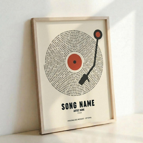 Framed poster print featuring a vinyl record design made of spiral text with red center label and black tonearm, displayed against white wall in light wood frame. Text spirals outward from center in black typography forming record grooves pattern. Bottom shows placeholder text for customizable song, artist and year details plus optional message. Cream colored paper background with minimalist design aesthetic.